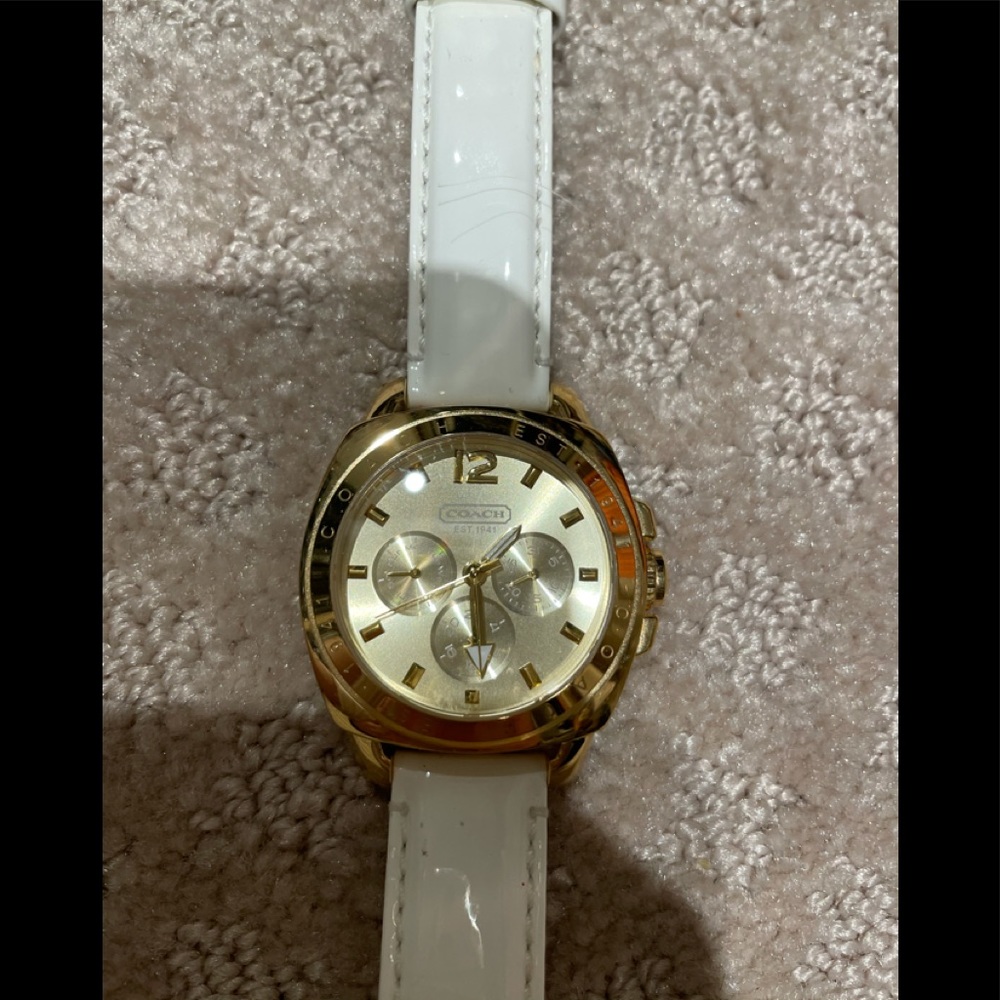 Coach watch. Gold white strap.